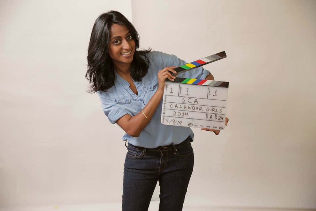 Meena holding a film slate